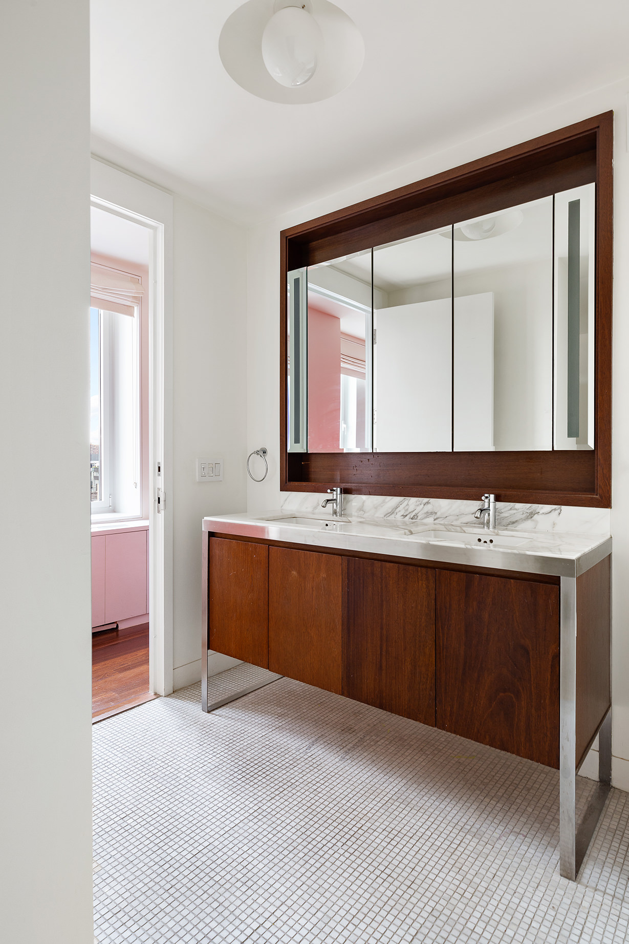 225 Lafayette Street, Unit 10D Manhattan, NY 10012 - Photo 6 of 14 a bathroom with a sink and a mirror