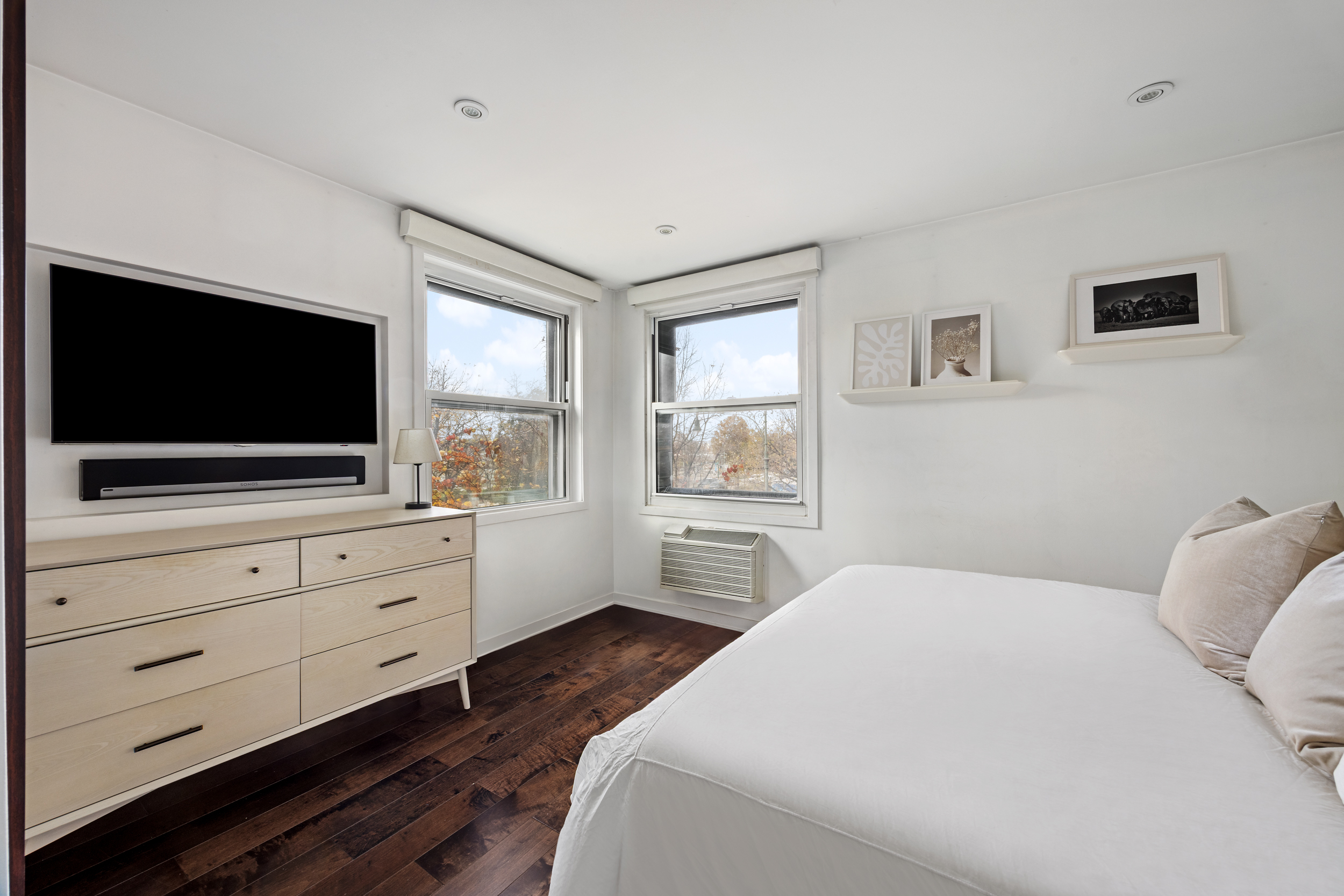 121 Morton Street, Unit 2A Manhattan, NY 10014 - Photo 5 of 9 a bedroom with a flat screen tv and a dresser