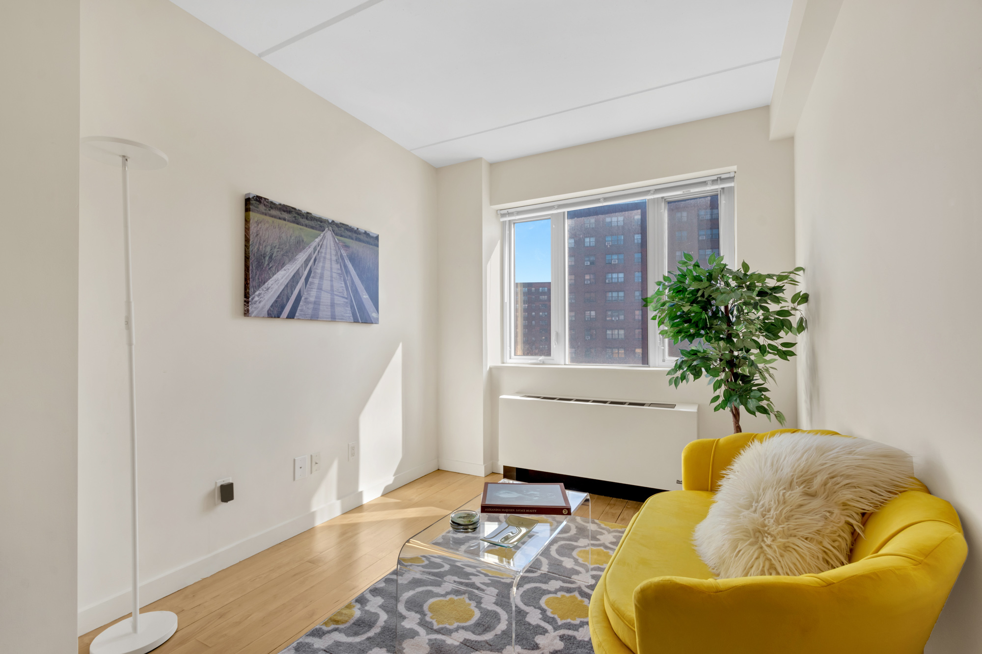 1810 3rd Avenue, Unit A7D Manhattan, NY 10029 - Photo 6 of 13 a living room with furniture and a potted plant