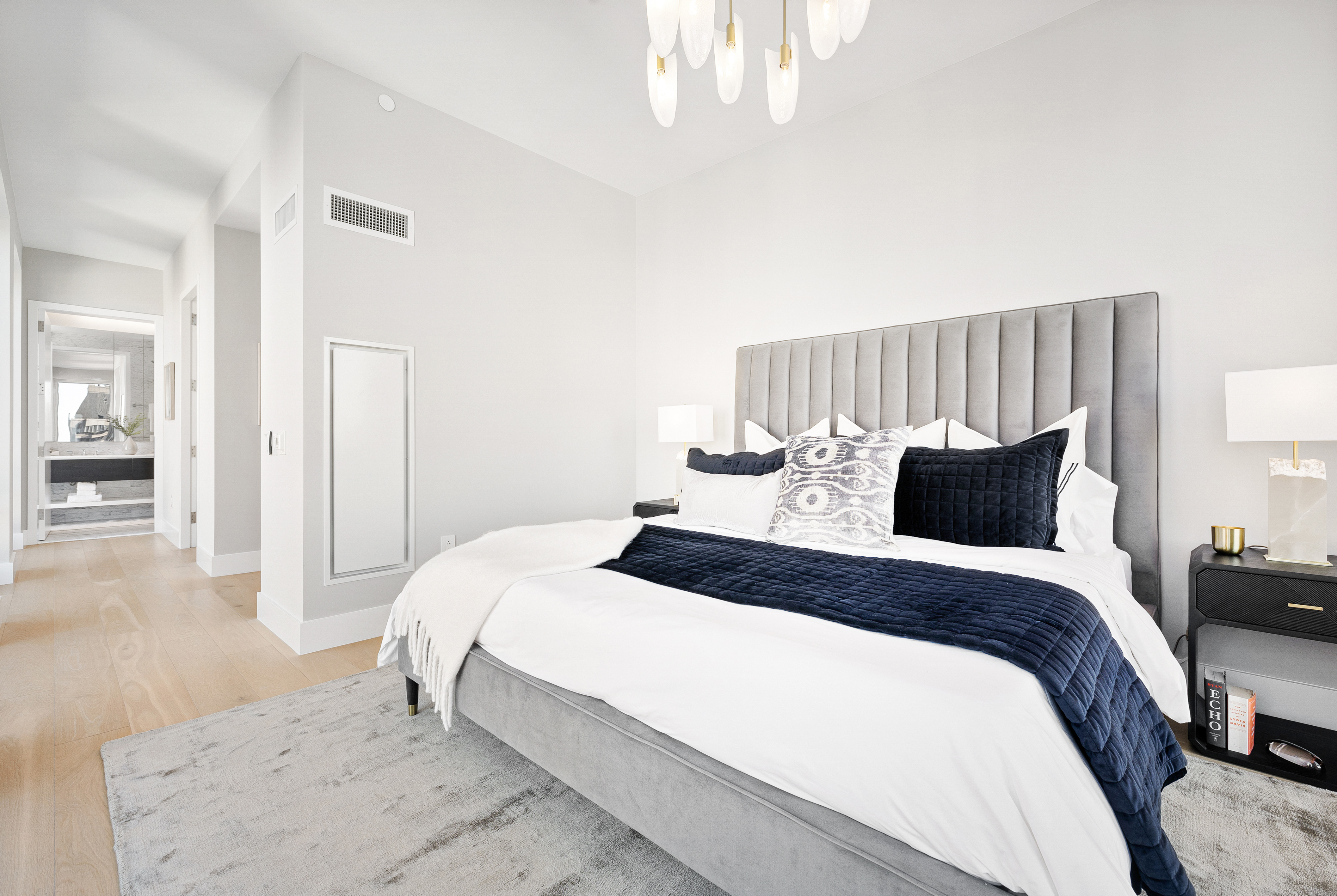 15 West 61st Street, Unit PH1C Manhattan, NY 10023 - Photo 16 of 26 a bedroom with a bed and a chandelier