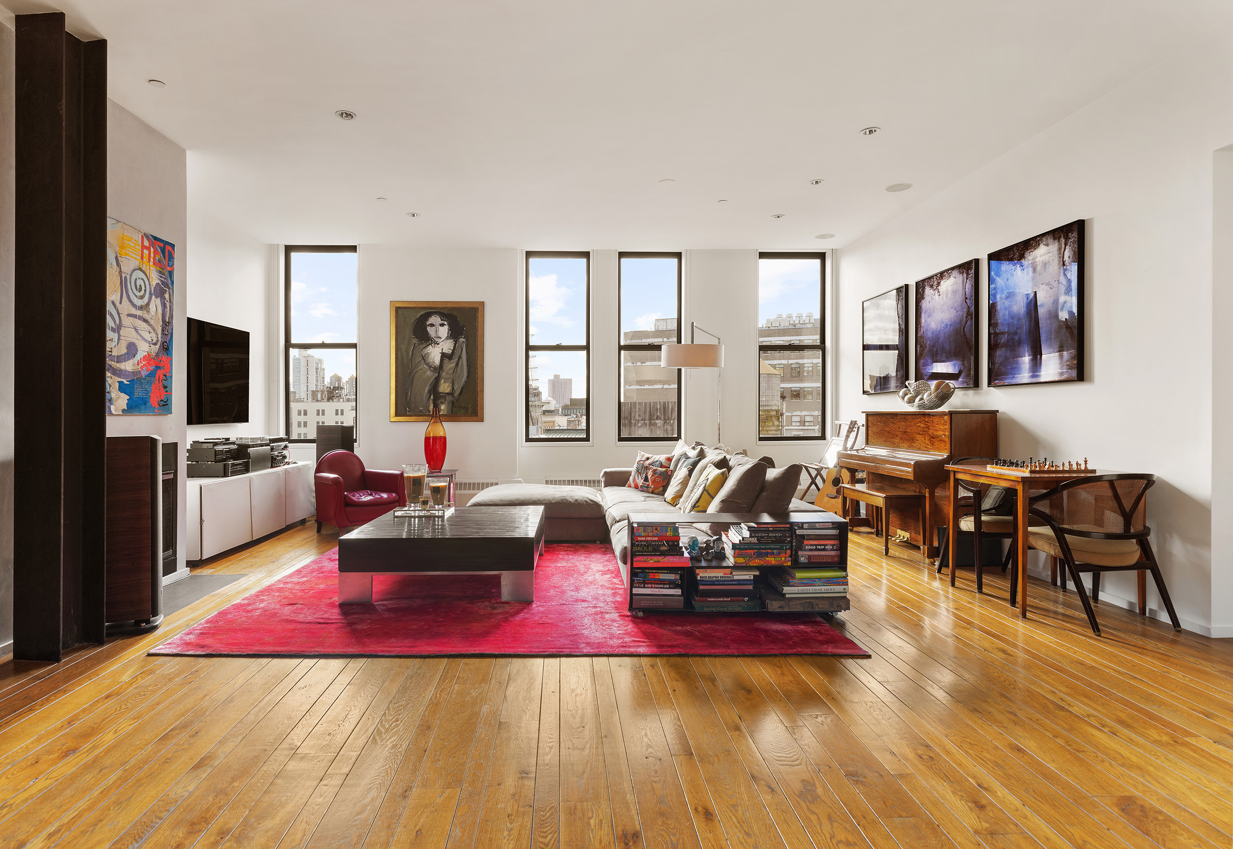 21 Astor Place, Unit 9E Manhattan, NY 10003 - Photo 1 of 10 a living room with furniture large window and flat screen tv