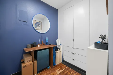 a view of a room with a mirror and a wooden floor