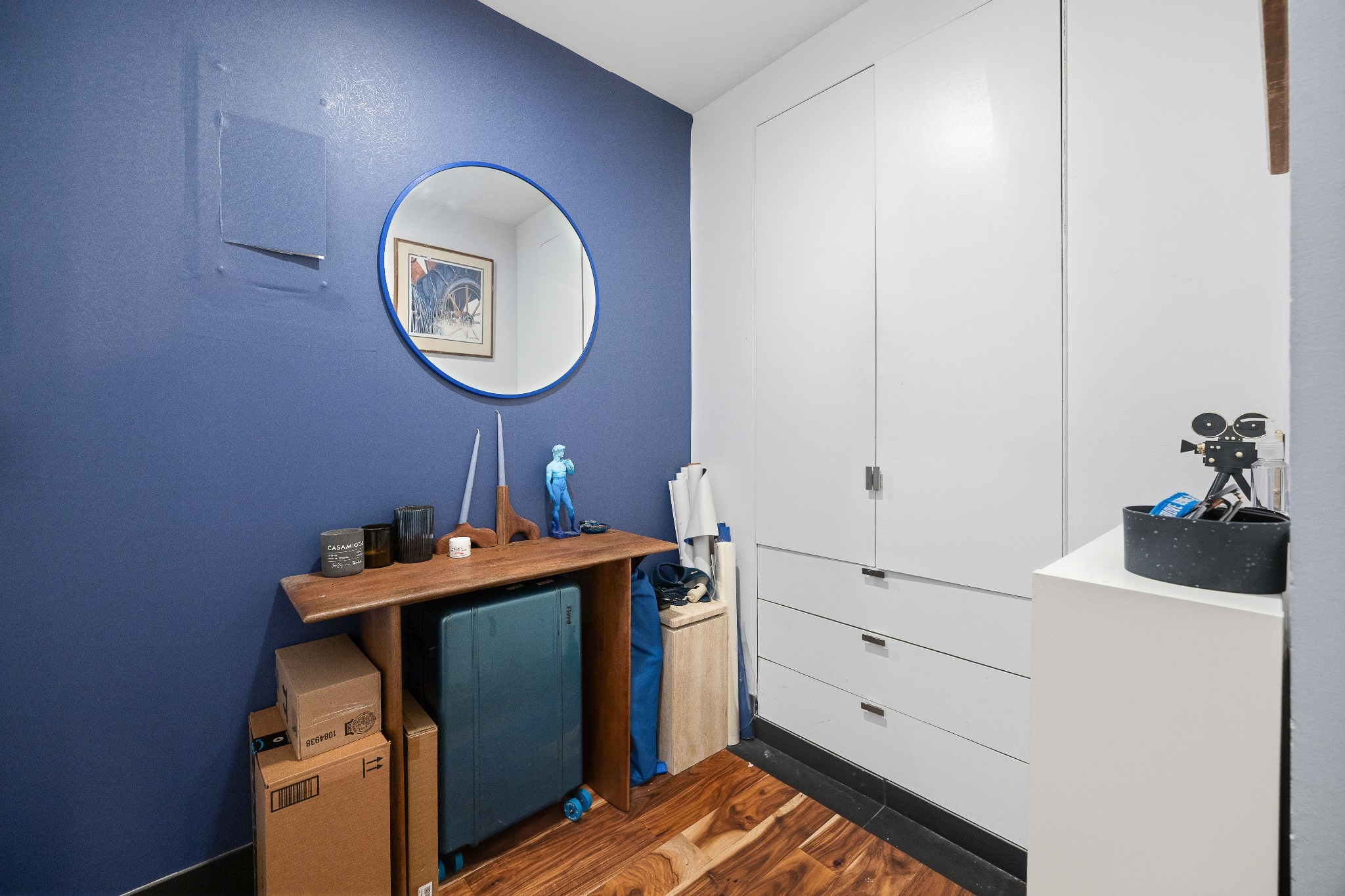 179 Grand Street, Unit 2F Manhattan, NY 10013 - Photo 9 of 11 a view of a room with a mirror and a wooden floor