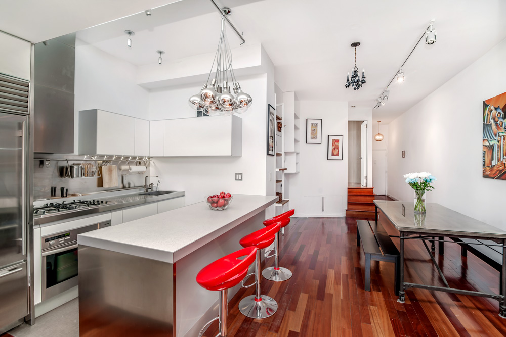 14 Prince Street, Unit 6C Manhattan, NY 10012 - Photo 3 of 9 a very nice looking kitchen with granite countertop a stove a sink dishwasher a dining table and chairs with wooden floor