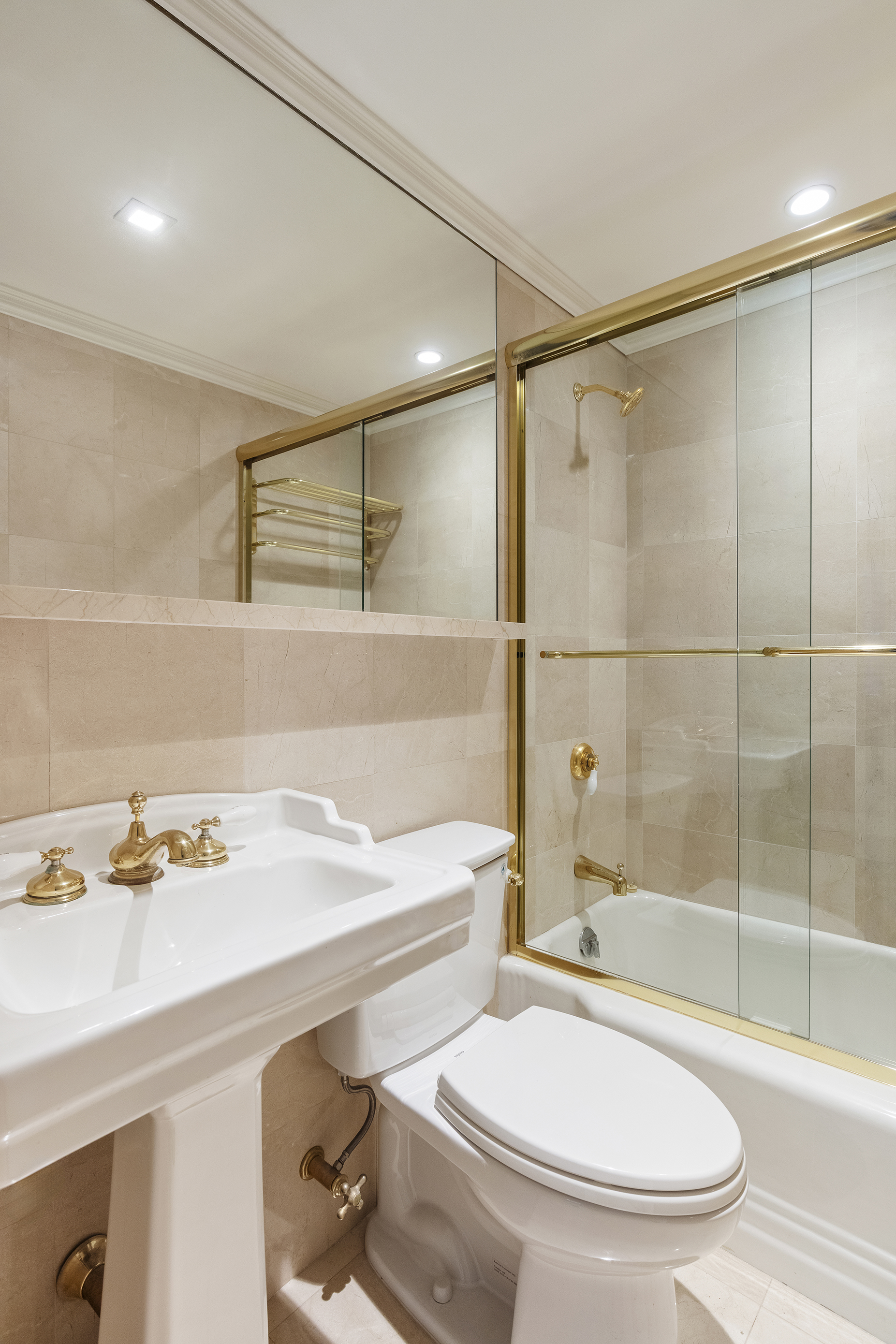 10 East 70th Street, Unit 3A Manhattan, NY 10021 - Photo 9 of 18 a bathroom with a sink a toilet and a bathtub