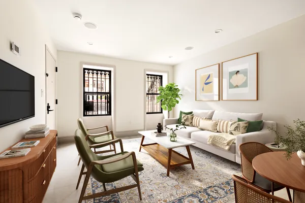 a living room with furniture a wooden floor and a flat screen tv