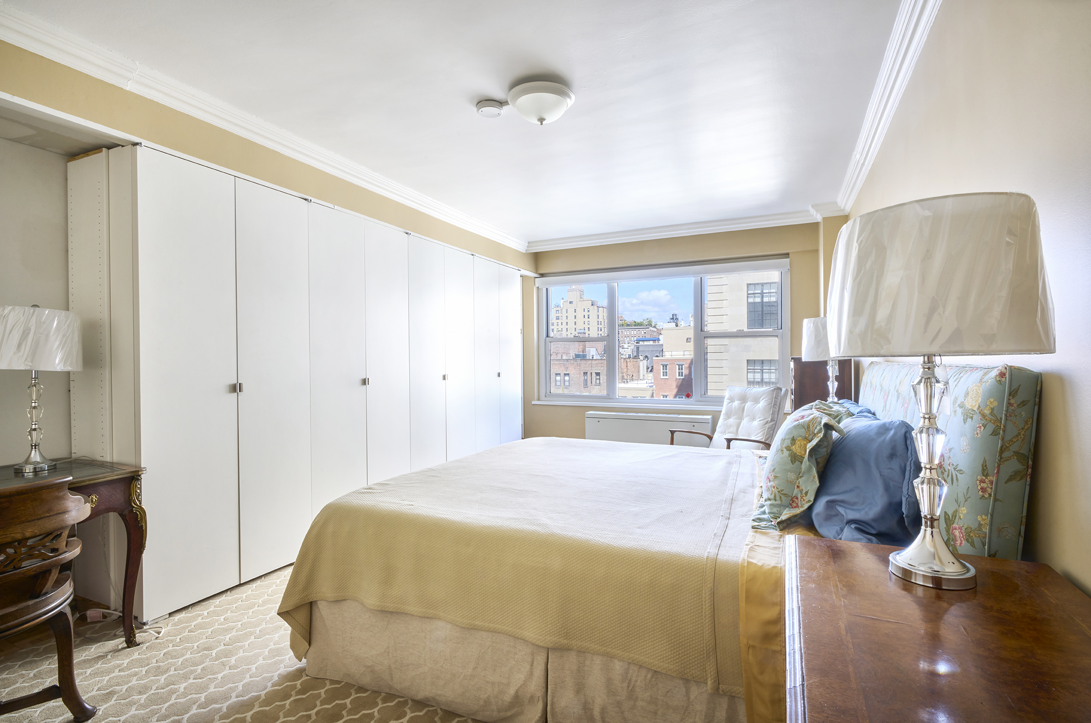 650 Park Avenue, Unit 10D Manhattan, NY 10065 - Photo 7 of 11 a bedroom with a bed and wooden floor