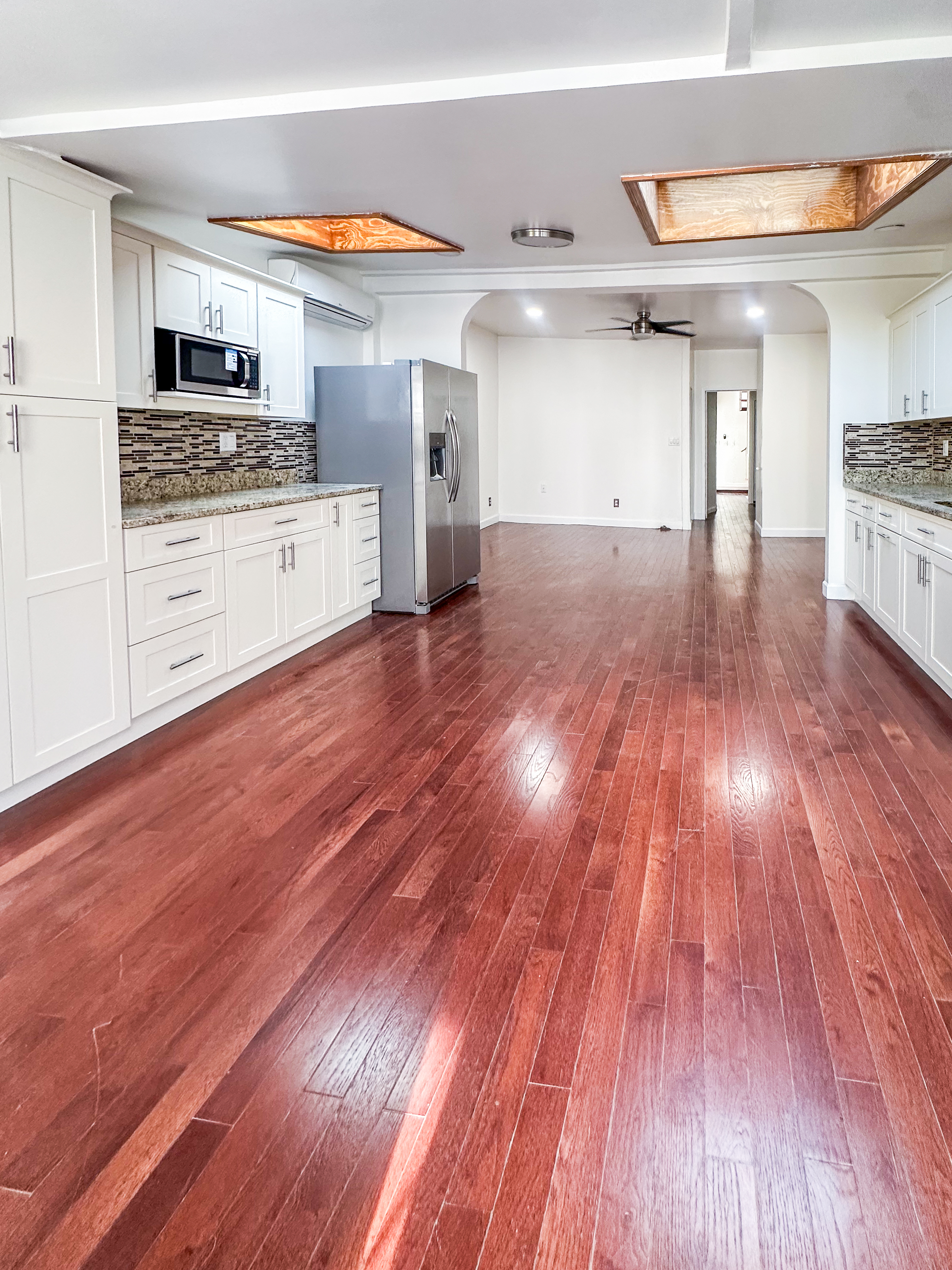289 A Cooper Street, Unit 2 Brooklyn, NY 11237 - Photo 5 of 19 a living room with stainless steel appliances wooden floors and kitchen view