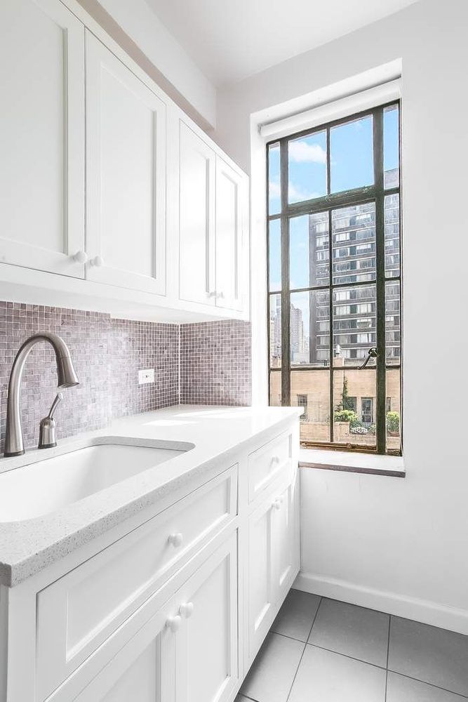 340 West 57th Street, Unit 14E Manhattan, NY 10019 - Photo 9 of 13 a kitchen with a sink and cabinets