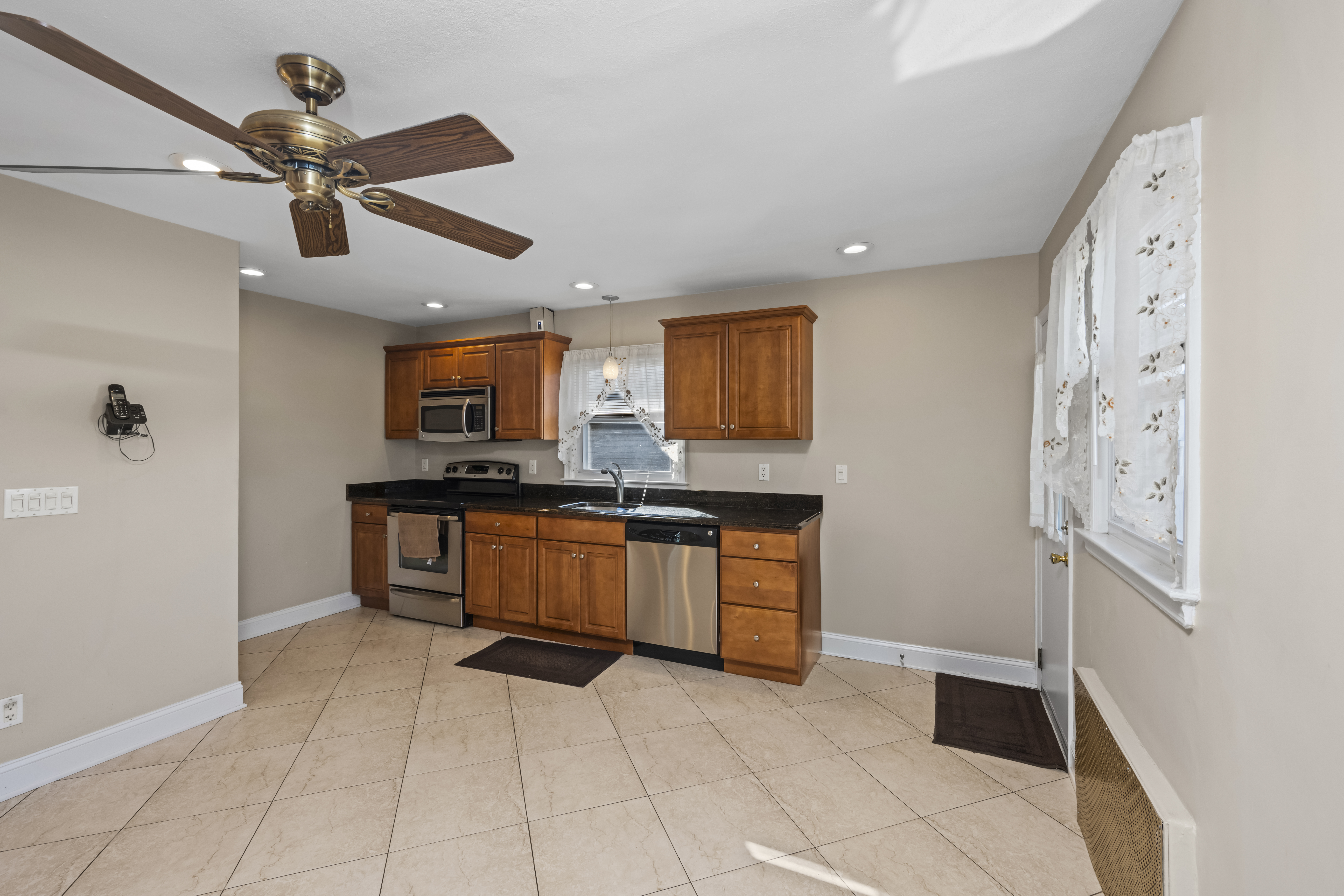 522 Stewart Avenue Staten Island, NY 10314 - Photo 13 of 33 a kitchen with stainless steel appliances a refrigerator and microwave
