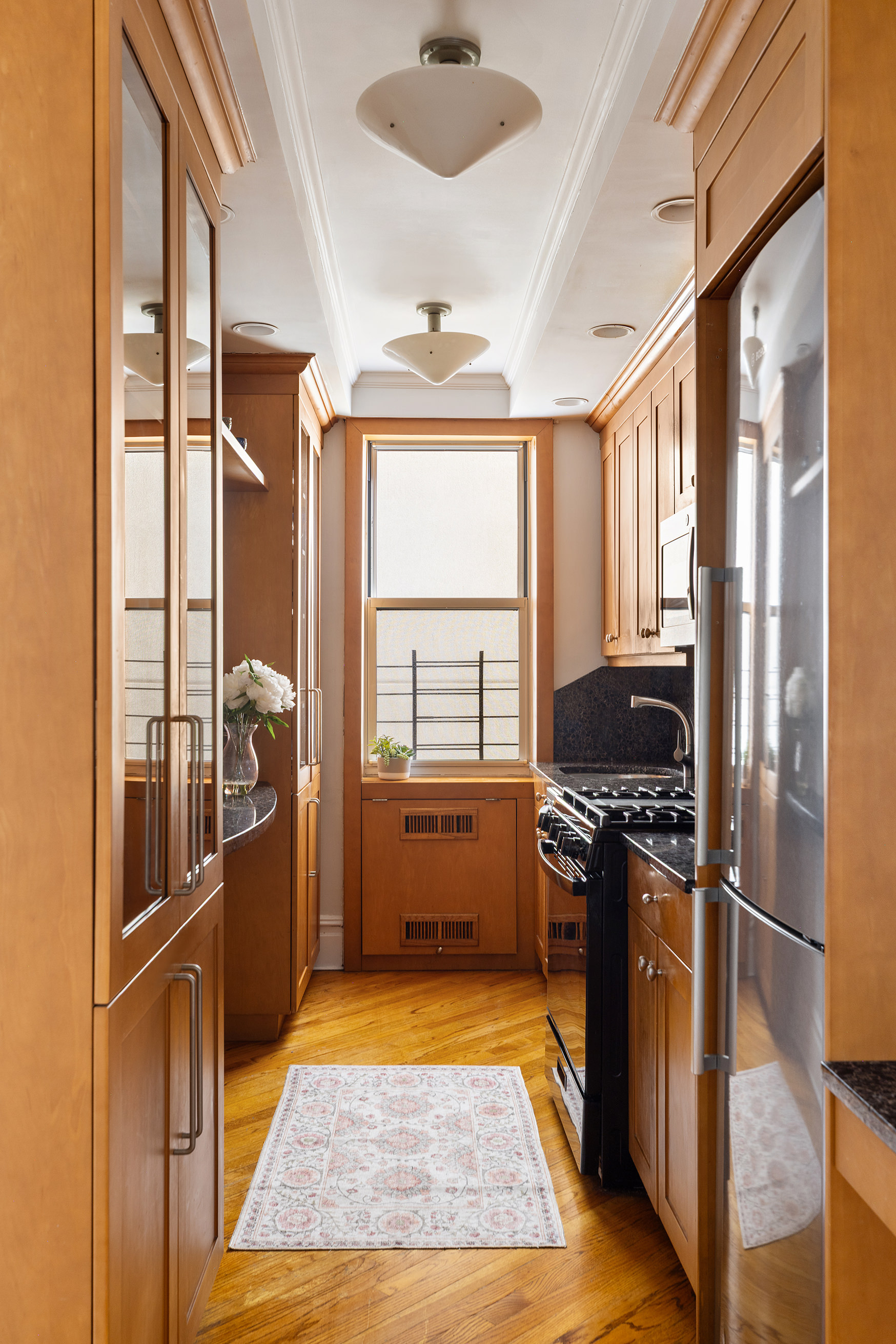 45 Plaza Street West, Unit 1F Brooklyn, NY 11217 - Photo 6 of 10 a kitchen with granite countertop a refrigerator and a stove