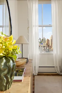 a room with a table and a chandelier