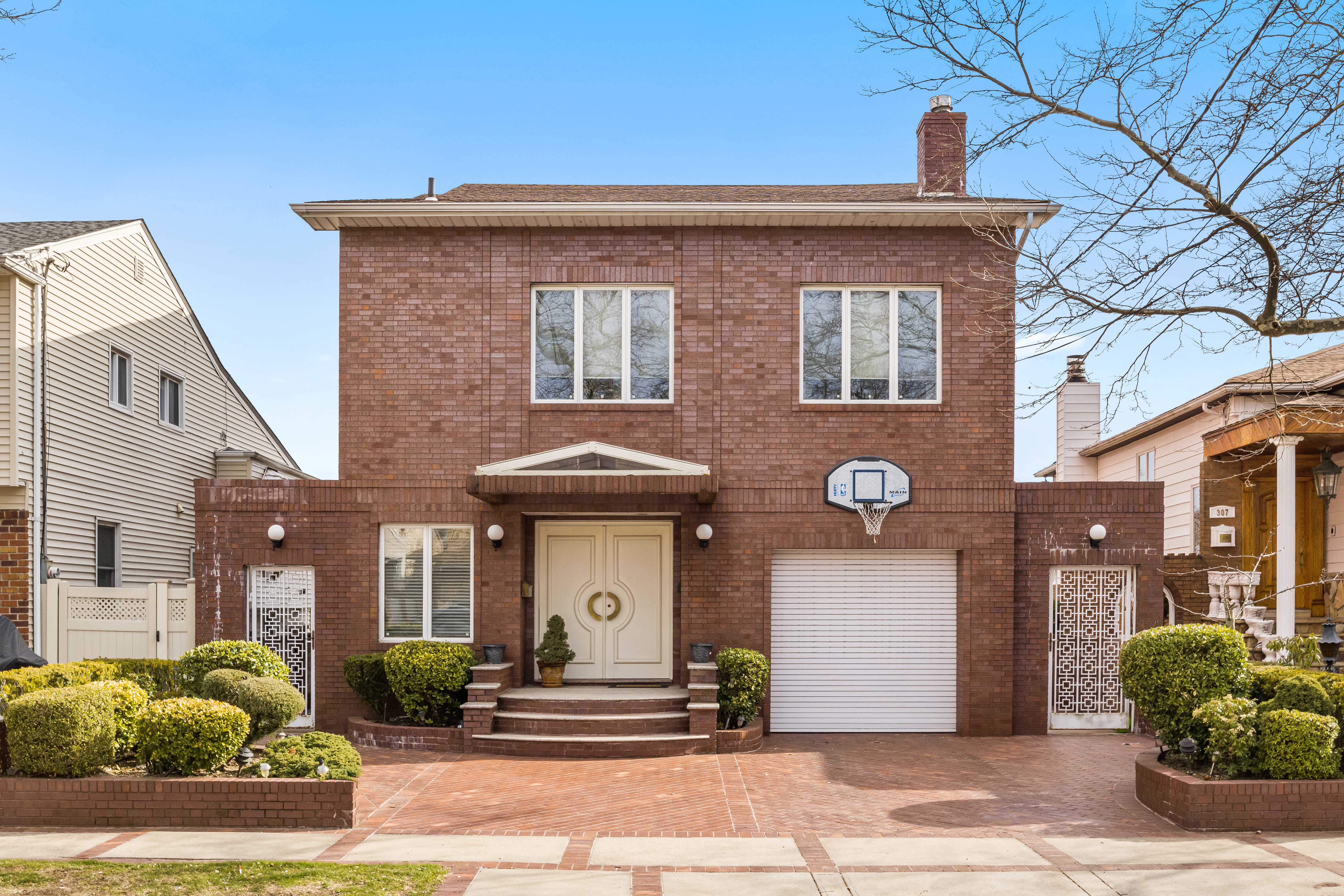 303 Whitman Drive Brooklyn, NY 11234 - Photo 2 of 37 a front view of a building with garden