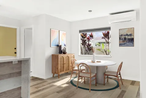 a dining room with furniture a window and a table