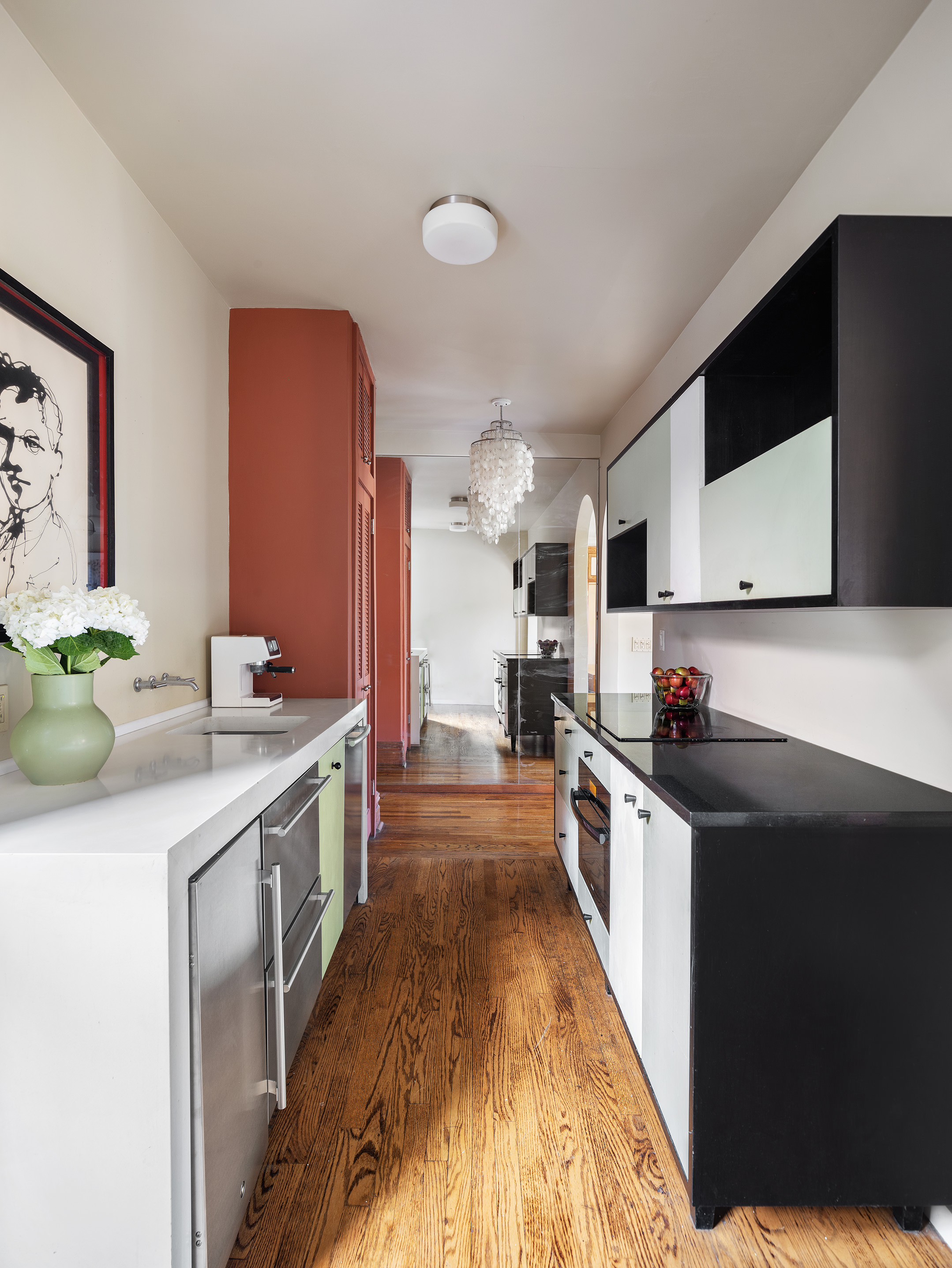 25 Charles Street, Unit 3B Manhattan, NY 10014 - Photo 3 of 9 a kitchen with stainless steel appliances granite countertop a sink a stove top oven a counter space and cabinets