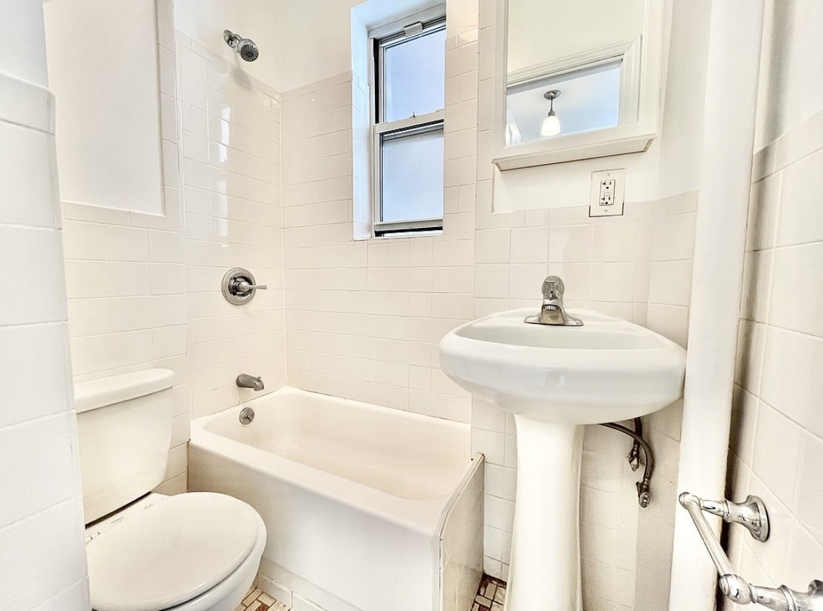 80 East 7th Street, Unit 4C Manhattan, NY 10003 - Photo 6 of 7 a bathroom with a sink a toilet and shower