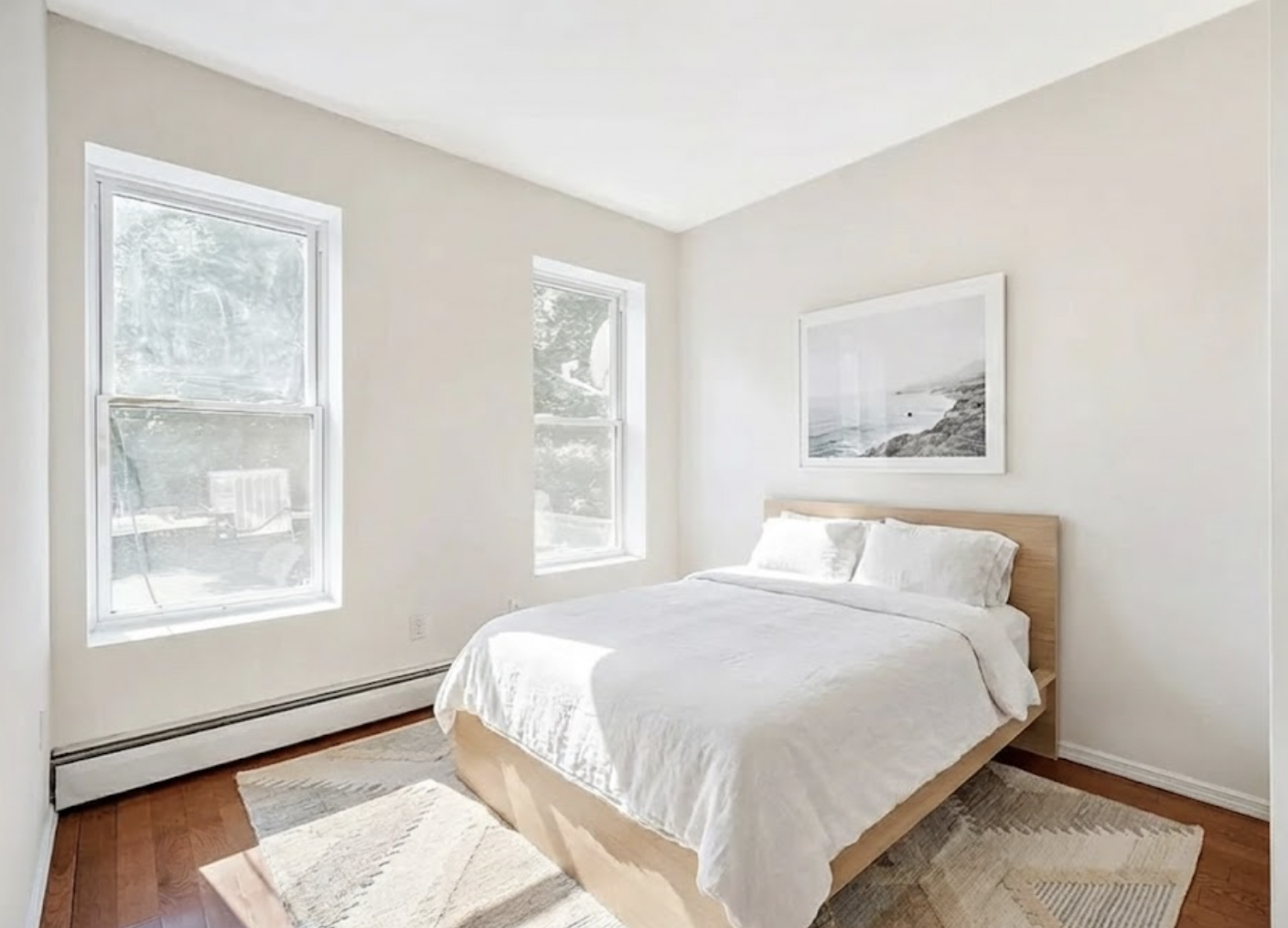 1402 Cortelyou Road, Unit 3 Brooklyn, NY 11226 - Photo 4 of 8 a large bed sitting in a bedroom next to a window