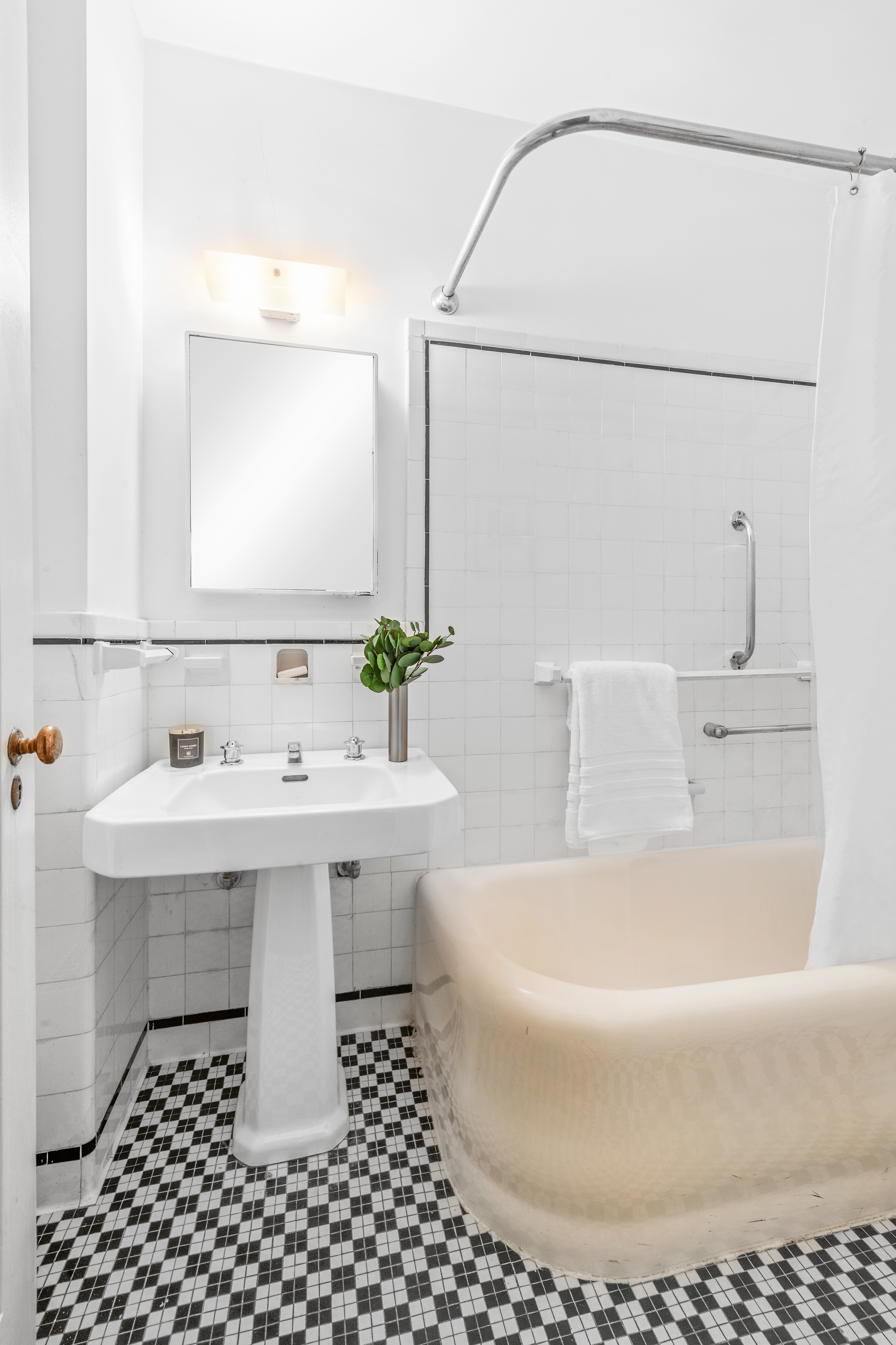 400 East 52nd Street, Unit 6K Manhattan, NY 10022 - Photo 7 of 8 a bathroom with a sink and a bathtub