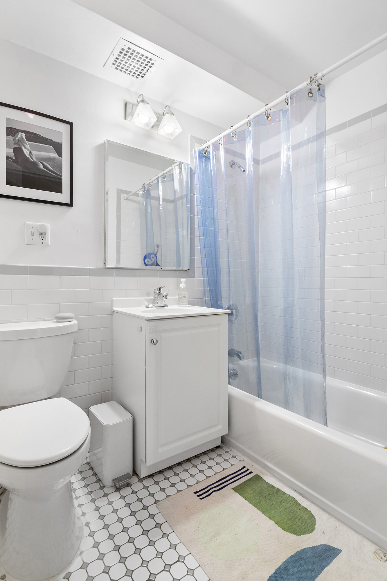 129 Boerum Place, Unit 5D Brooklyn, NY 11201 - Photo 5 of 9 a bathroom with a sink a toilet and shower