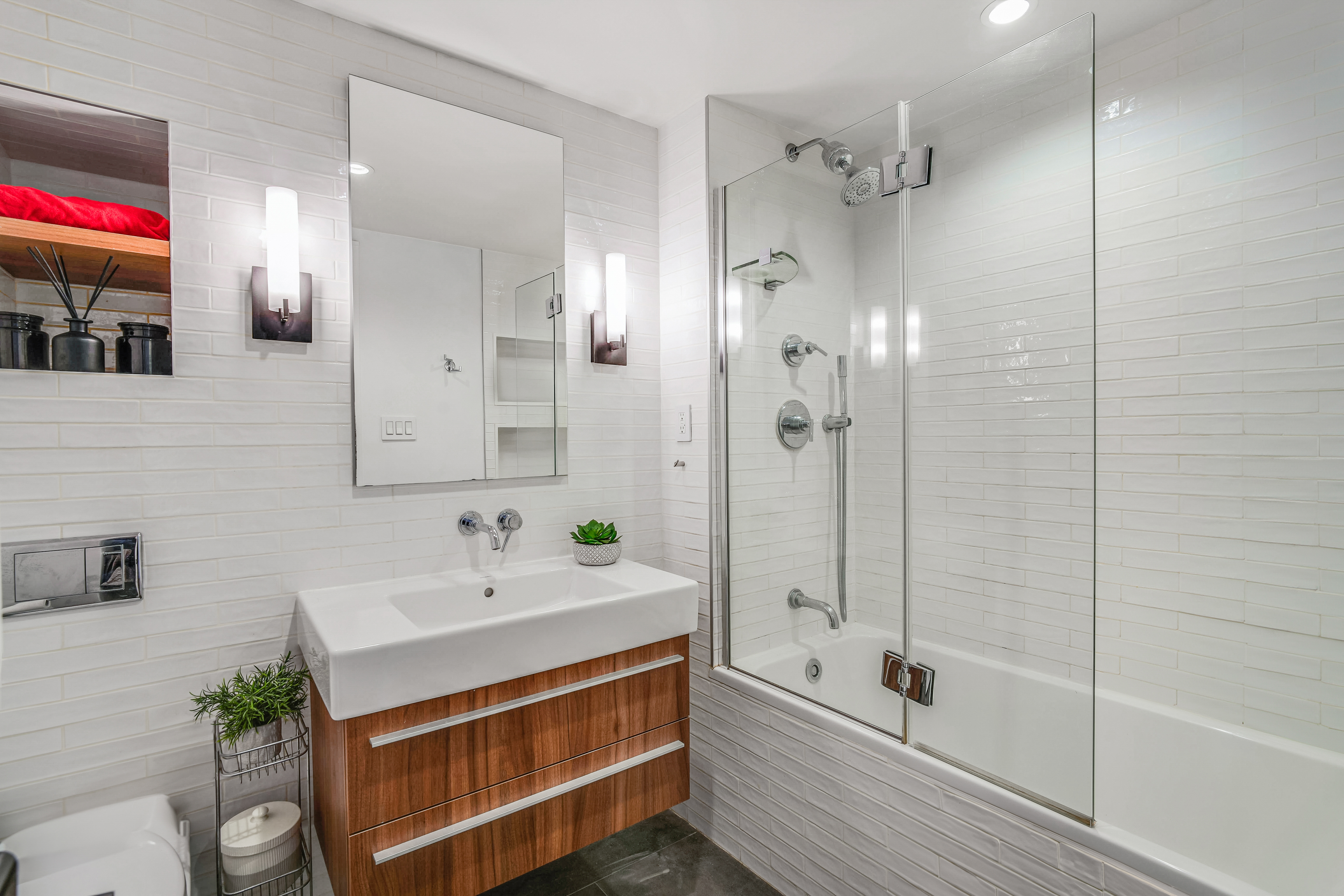 60 Pineapple Street, Unit 7I Brooklyn, NY 11201 - Photo 9 of 14 a bathroom with a tub sink shower and mirror