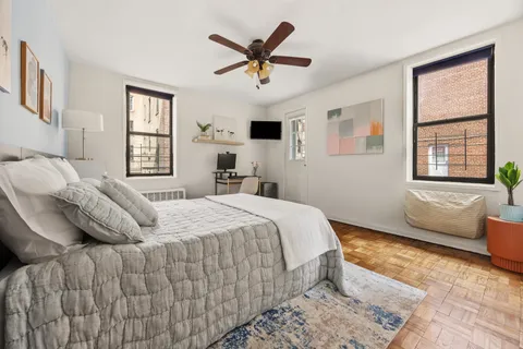 a bedroom with a bed and window