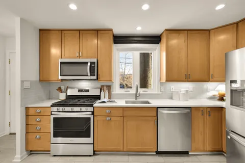a kitchen with a sink stove and microwave