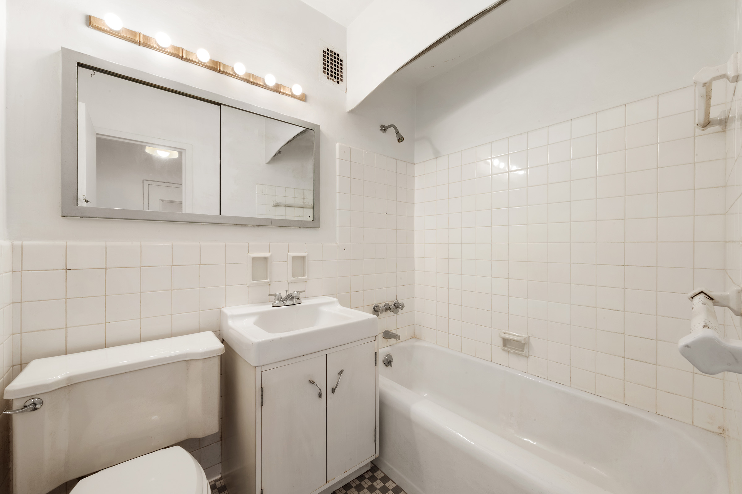 16 Sutton Place, Unit 15C Manhattan, NY 10022 - Photo 8 of 13 a bathroom with a toilet sink and mirror
