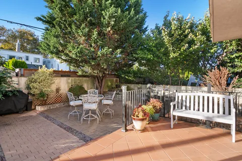a view of a chair and tables in the patio