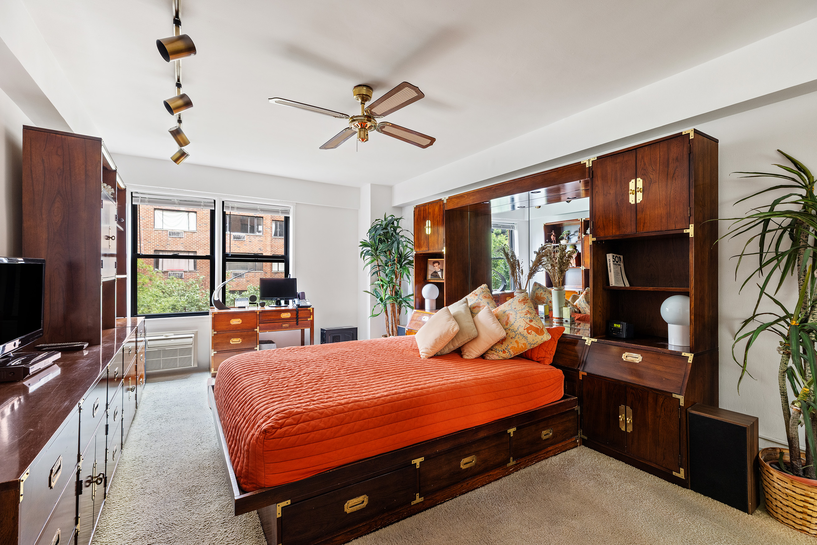 515 East 85th Street, Unit 6D Manhattan, NY 10028 - Photo 10 of 16 a bedroom with a bed flat screen tv and a large window
