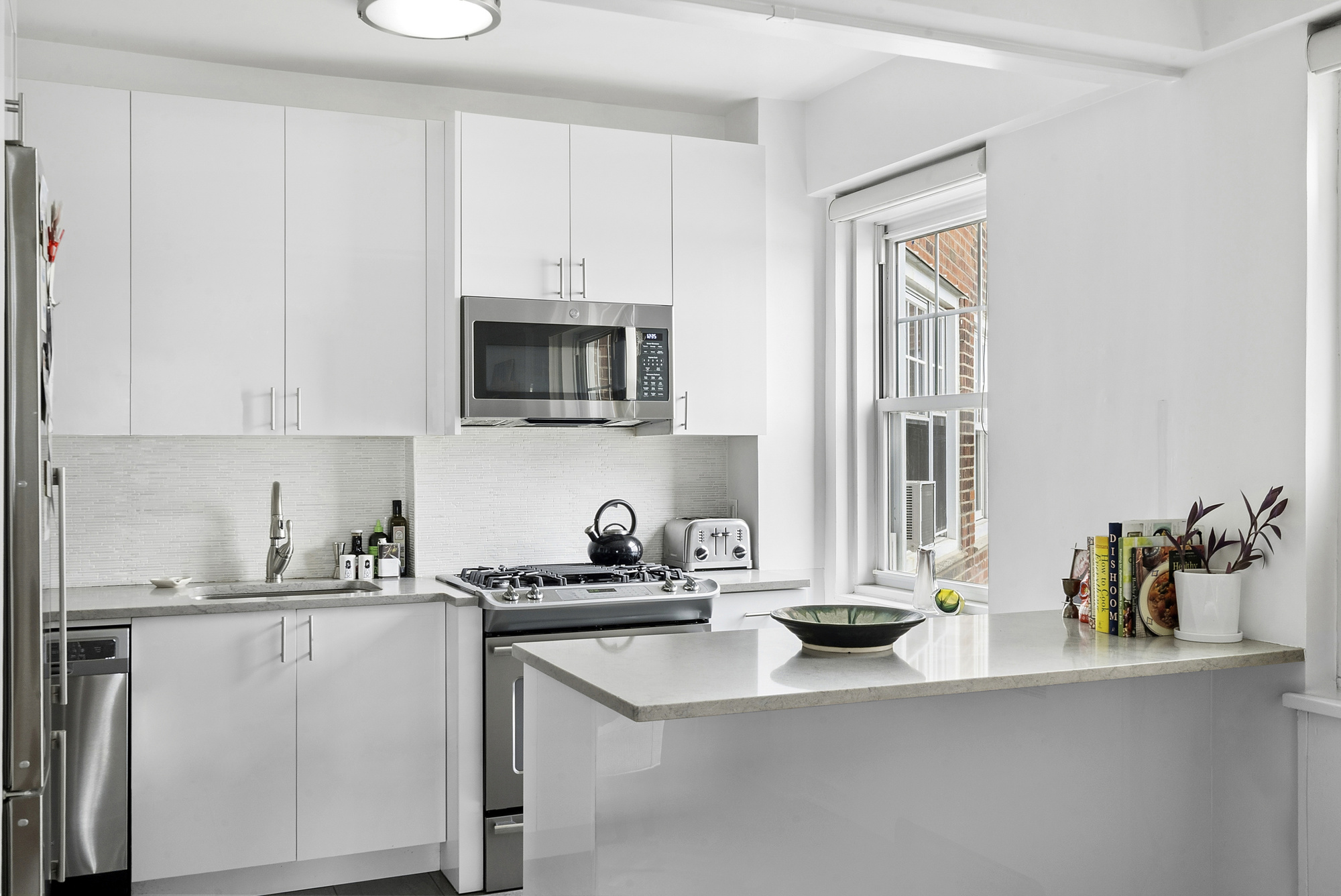 160 Cabrini Boulevard, Unit 89 Manhattan, NY 10033 - Photo 5 of 17 a kitchen with a sink cabinets and a window