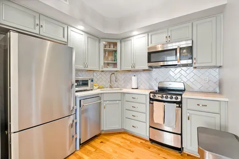 a kitchen with stainless steel appliances granite countertop a refrigerator stove a sink dishwasher and microwave with cabinets