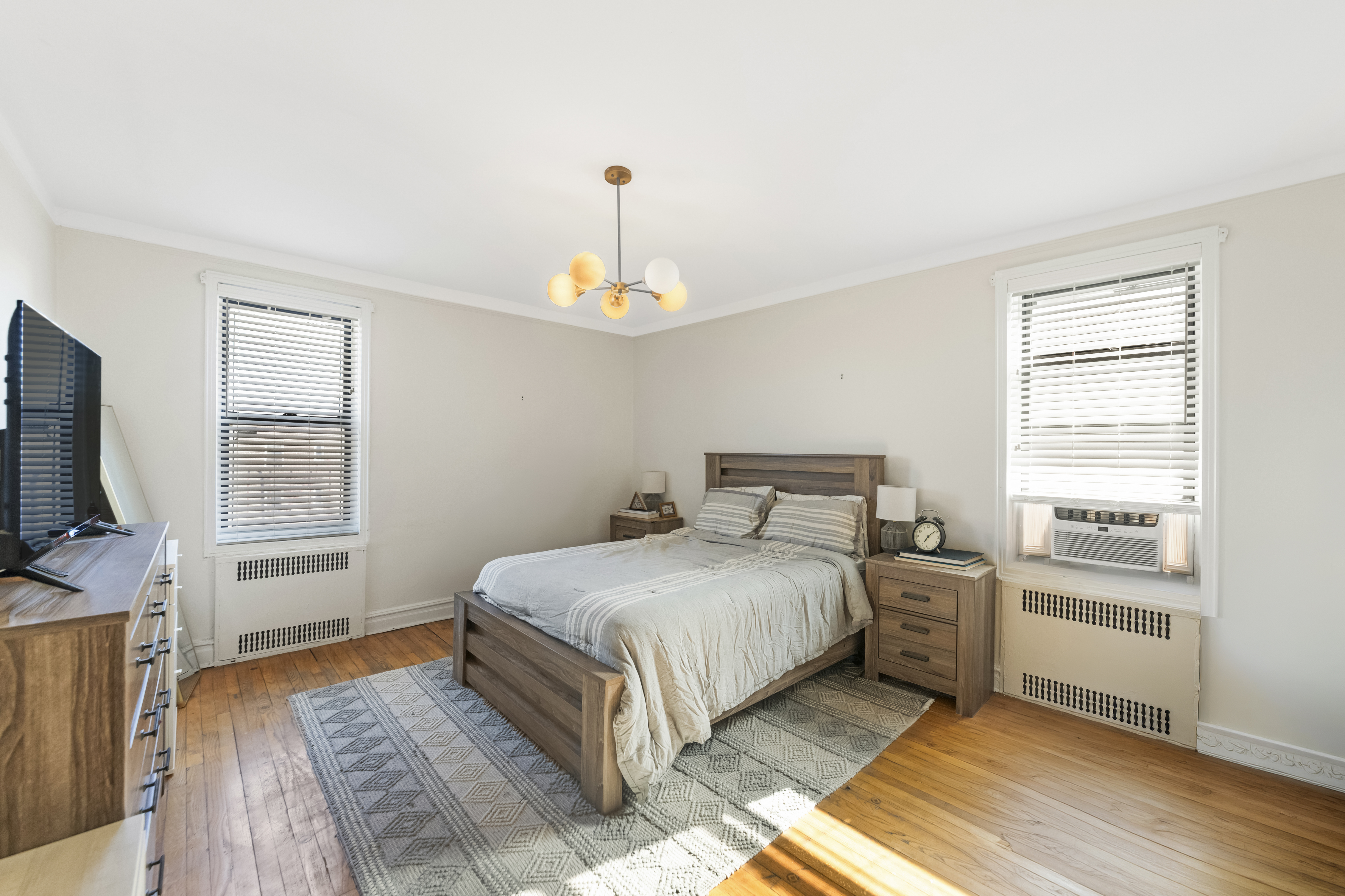 3220 Avenue H, Unit 6N Brooklyn, NY 11210 - Photo 5 of 9 a bedroom with a bed and a flat screen tv