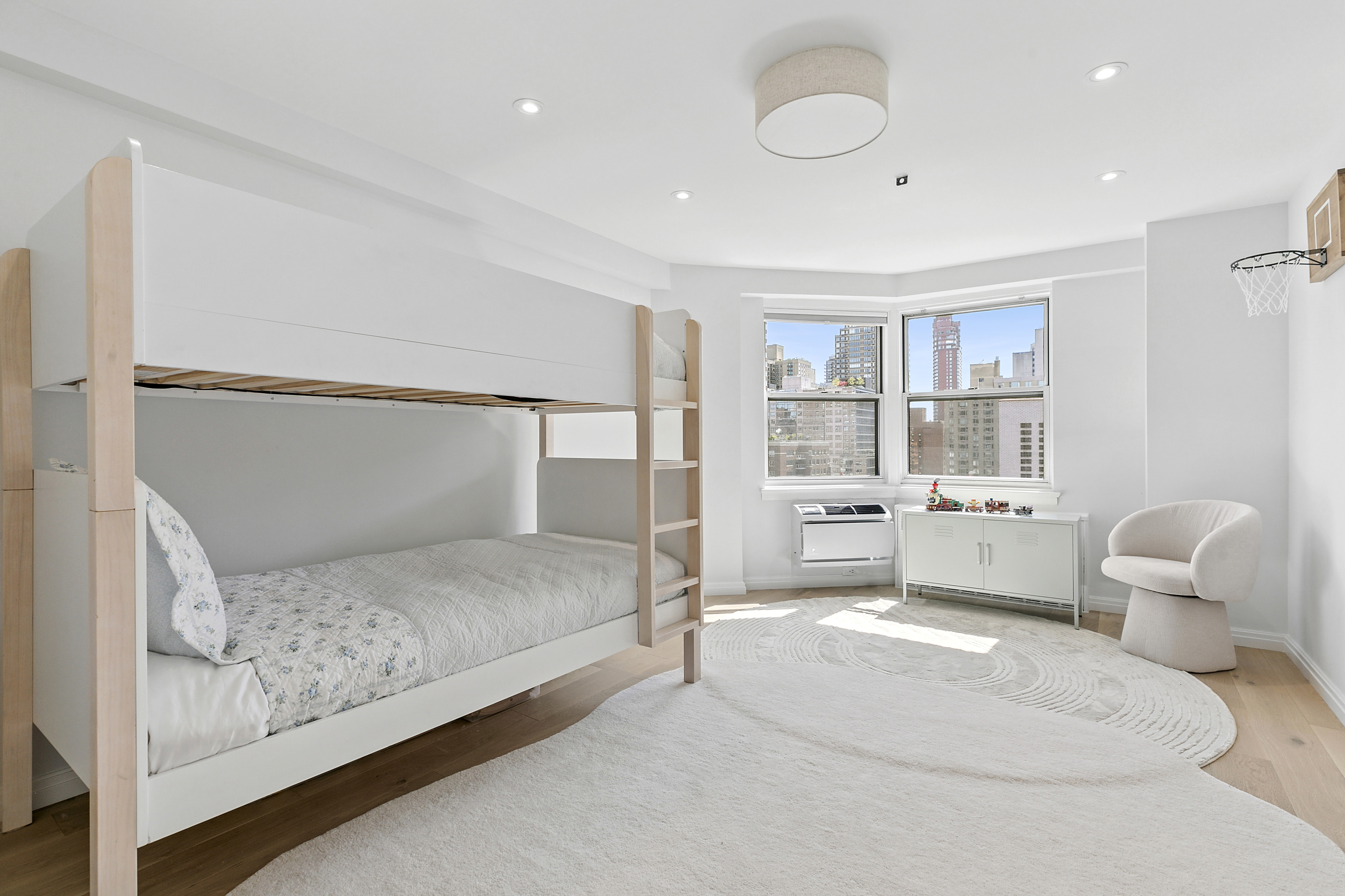 300 East 71st Street, Unit 17DEF Manhattan, NY 10021 - Photo 8 of 16 a spacious bedroom with a bed and a large window