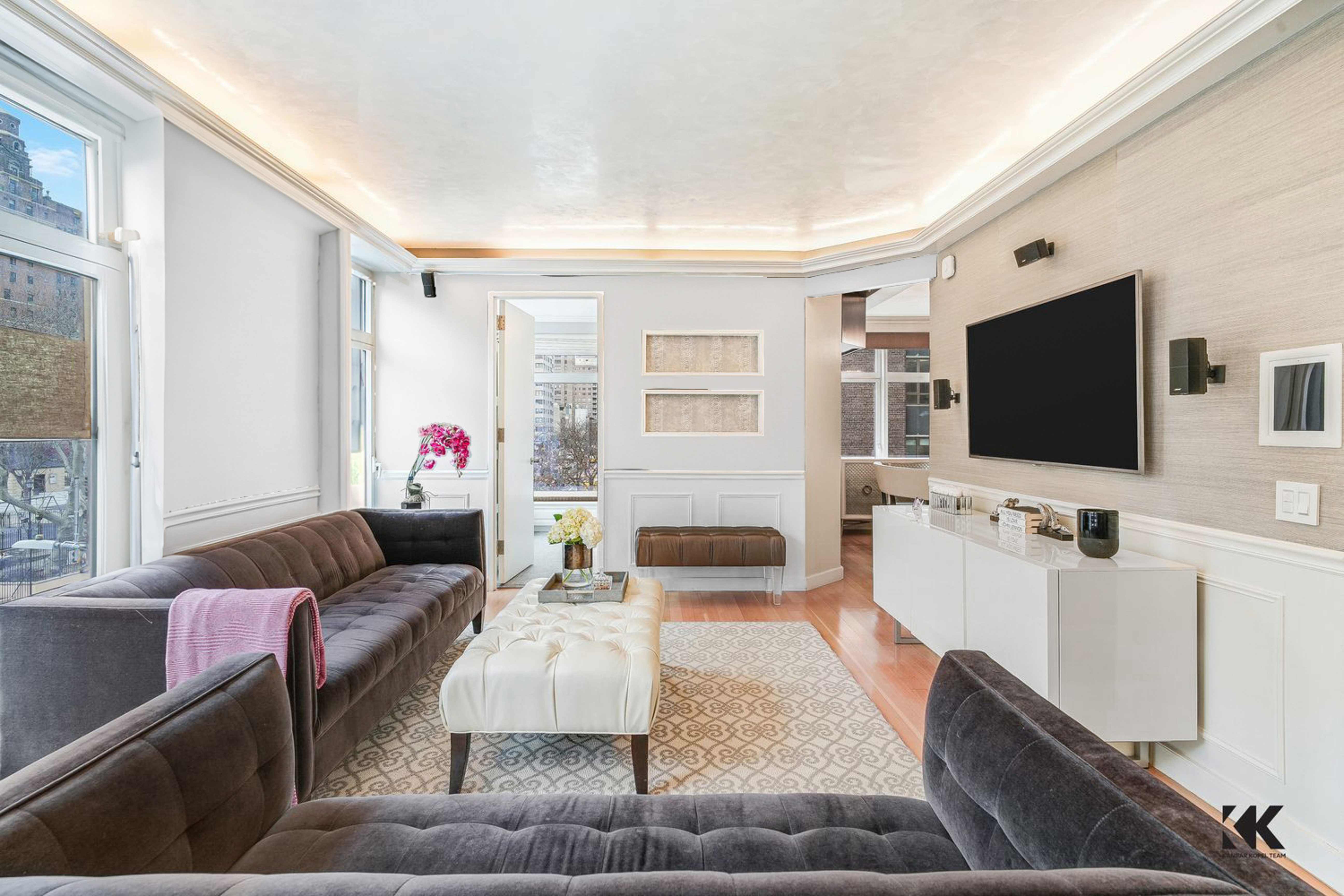 400 East 67th Street, Unit 3CD Manhattan, NY 10065 - Photo 3 of 28 a living room with furniture and a flat screen tv