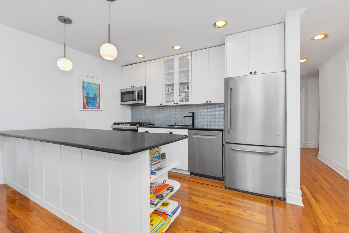 74 2nd Place, Unit 2B Brooklyn, NY 11231 - Photo 2 of 14 a kitchen with granite countertop a refrigerator a sink and a stove