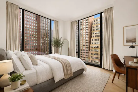 a bedroom with a large bed and a large window