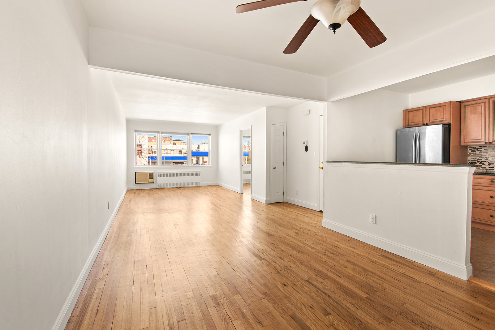 572 92nd Street Brooklyn, NY 11209 - Photo 2 of 20 wooden floor in an empty room with a window