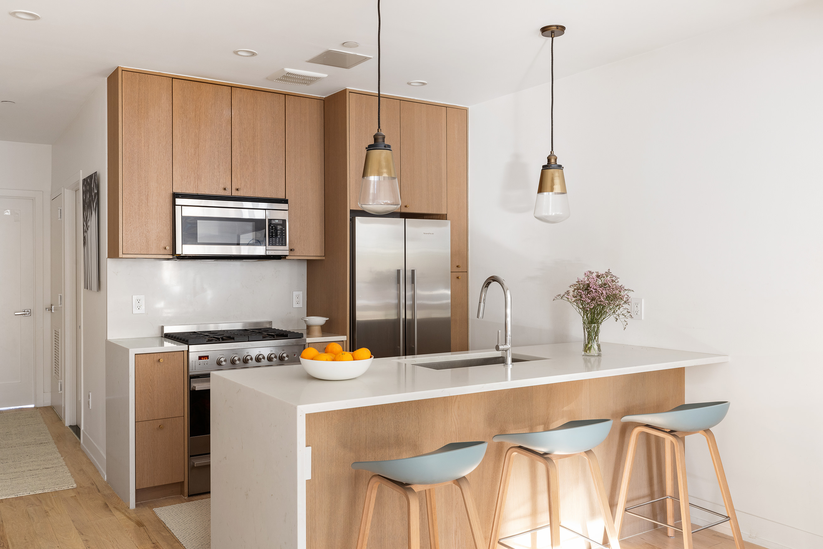 207 Wyckoff Street, Unit 2 Brooklyn, NY 11217 - Photo 7 of 15 a kitchen with stainless steel appliances granite countertop a sink a stove and a refrigerator