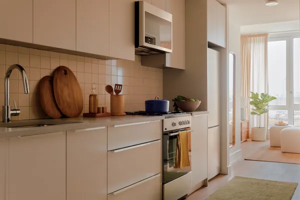 a kitchen with stainless steel appliances granite countertop a refrigerator and a stove
