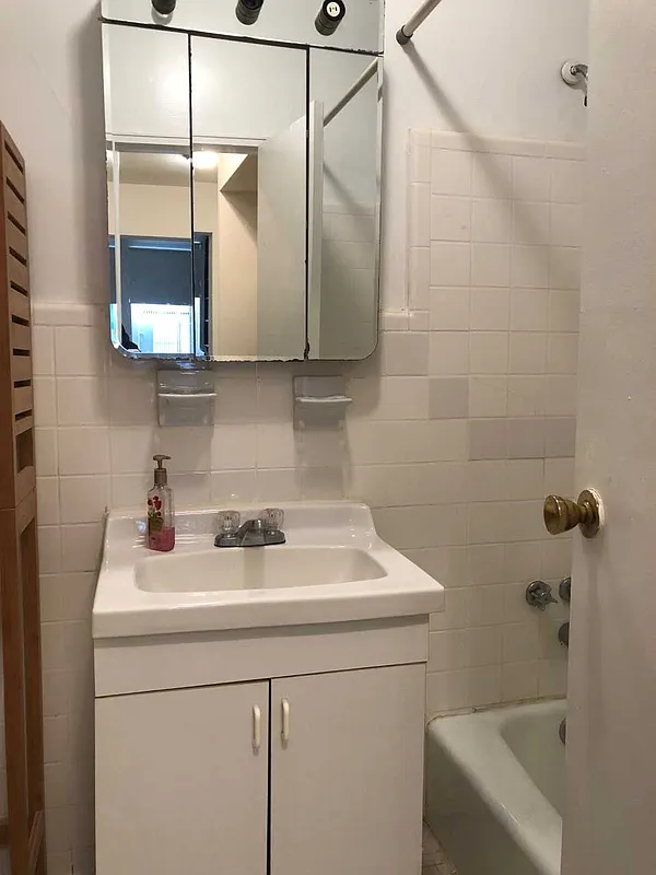 237 East 79th Street, Unit 1B Manhattan, NY 10075 - Photo 7 of 7 a bathroom with a sink and a vanity