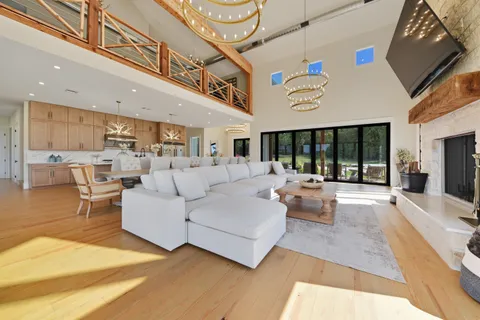 a living room with furniture and large windows