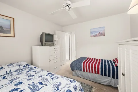 a bedroom with a bed and a television