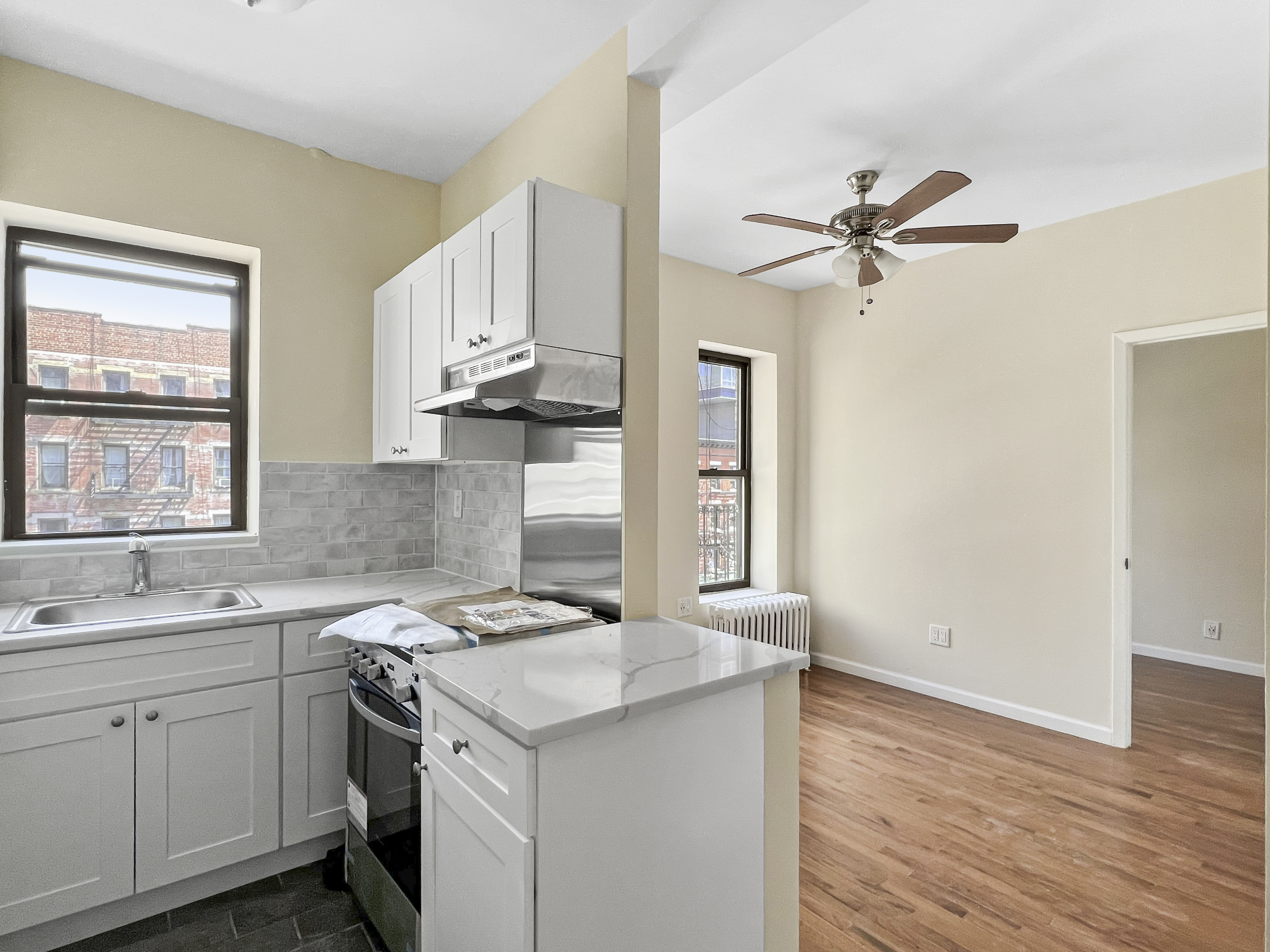 a kitchen with a sink cabinets appliances and a window
