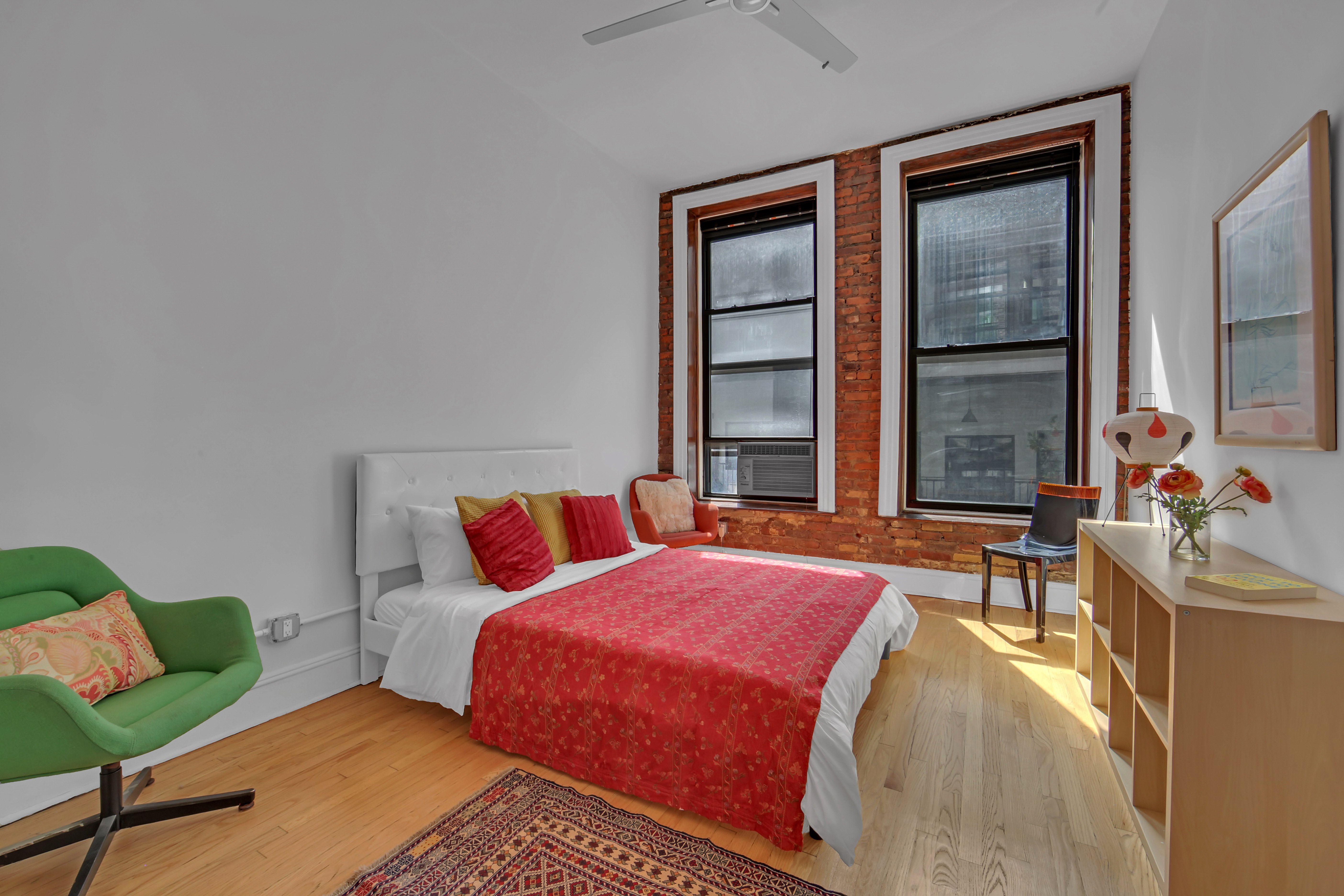 56 East 11th Street, Unit 7 Manhattan, NY 10003 - Photo 12 of 16 a bedroom with a bed and windows
