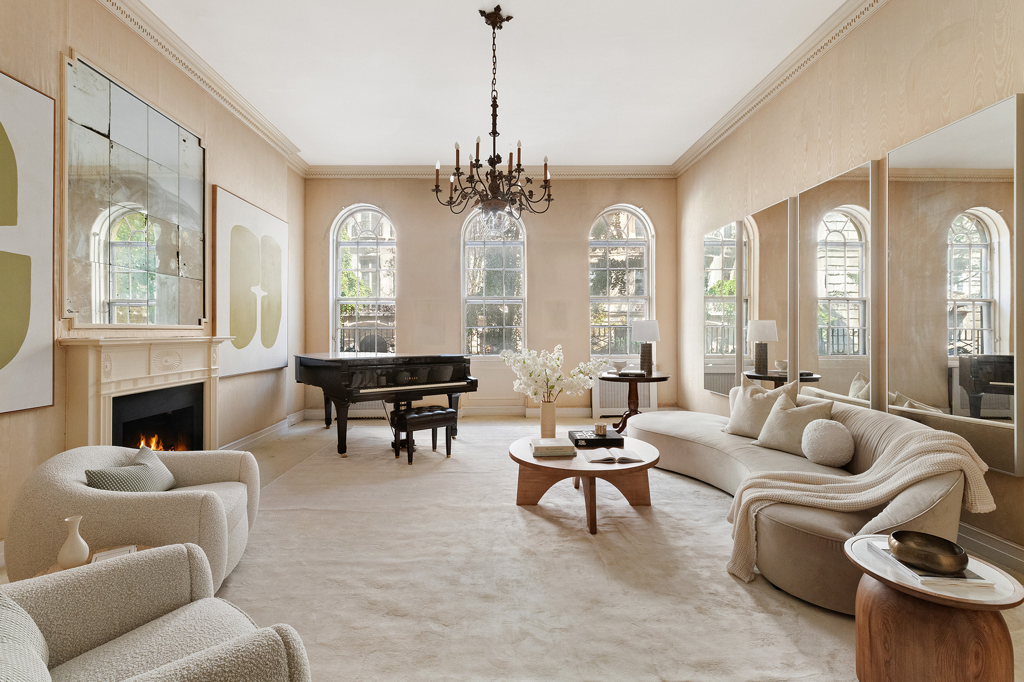 a living room with furniture a fireplace and a chandelier