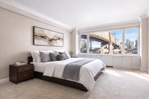 a bedroom with a bed and a large window