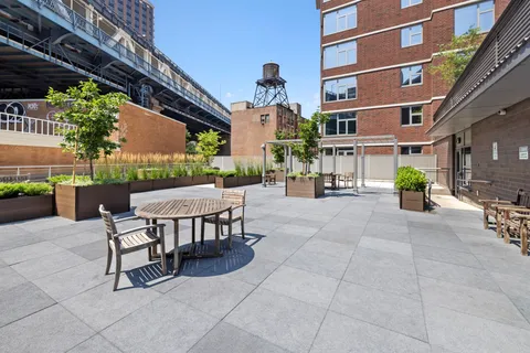 a view of a patio with a table and chairs and potted plants