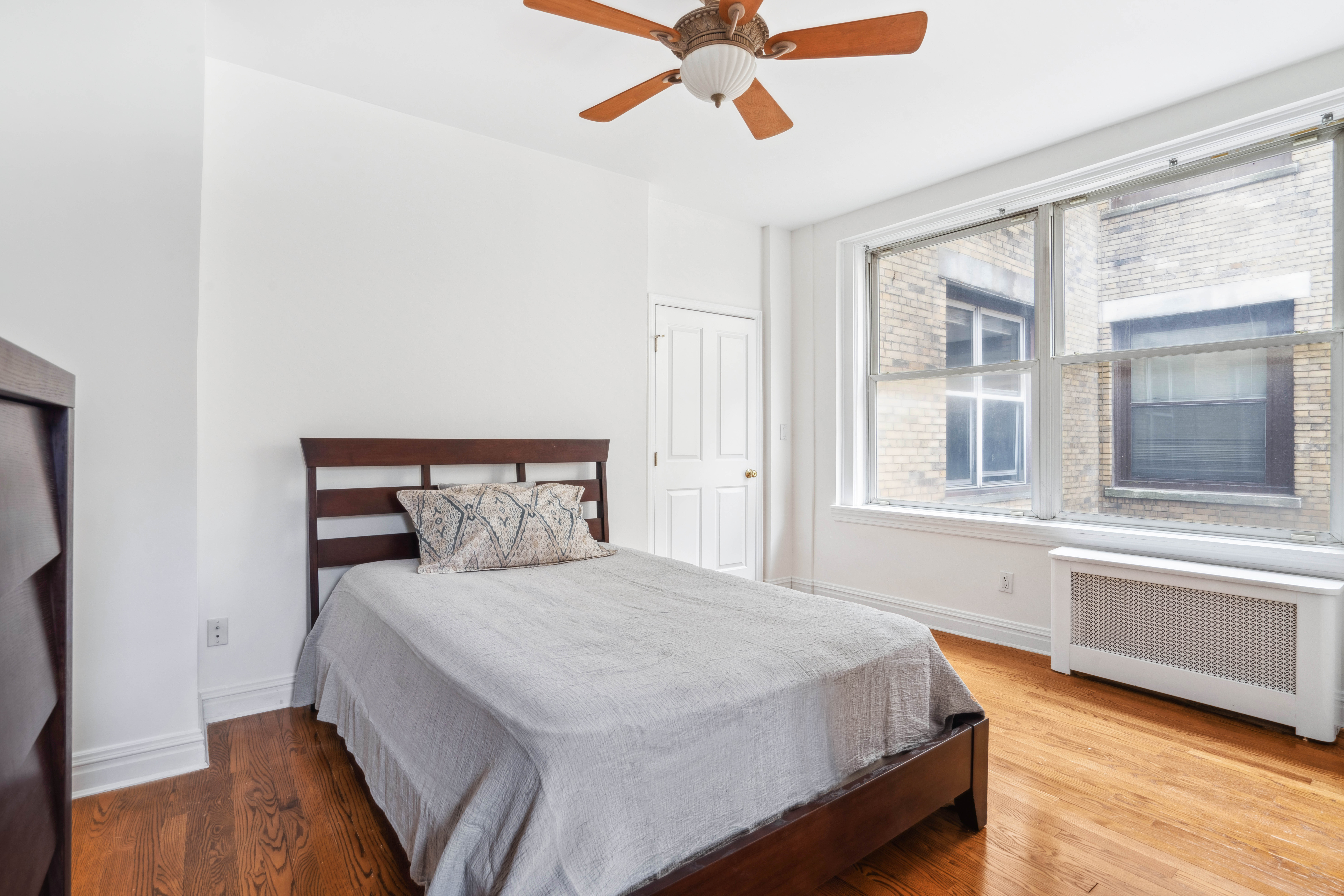 380 Riverside Drive, Unit 7B Manhattan, NY 10025 - Photo 5 of 12 a bedroom with a bed and wooden floor