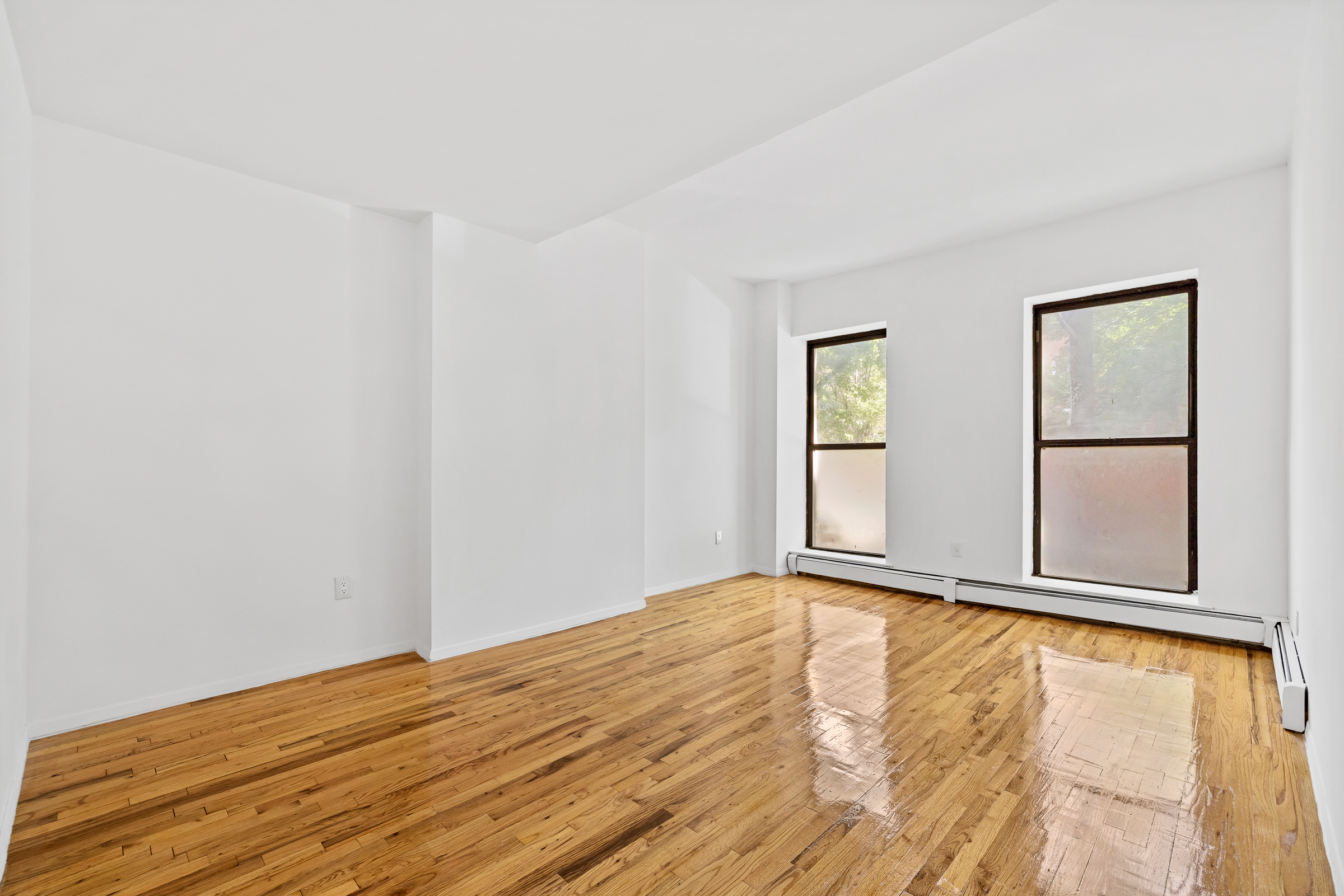 662 Warren Street Brooklyn, NY 11217 - Photo 4 of 9 a view of an empty room with window and wooden floor