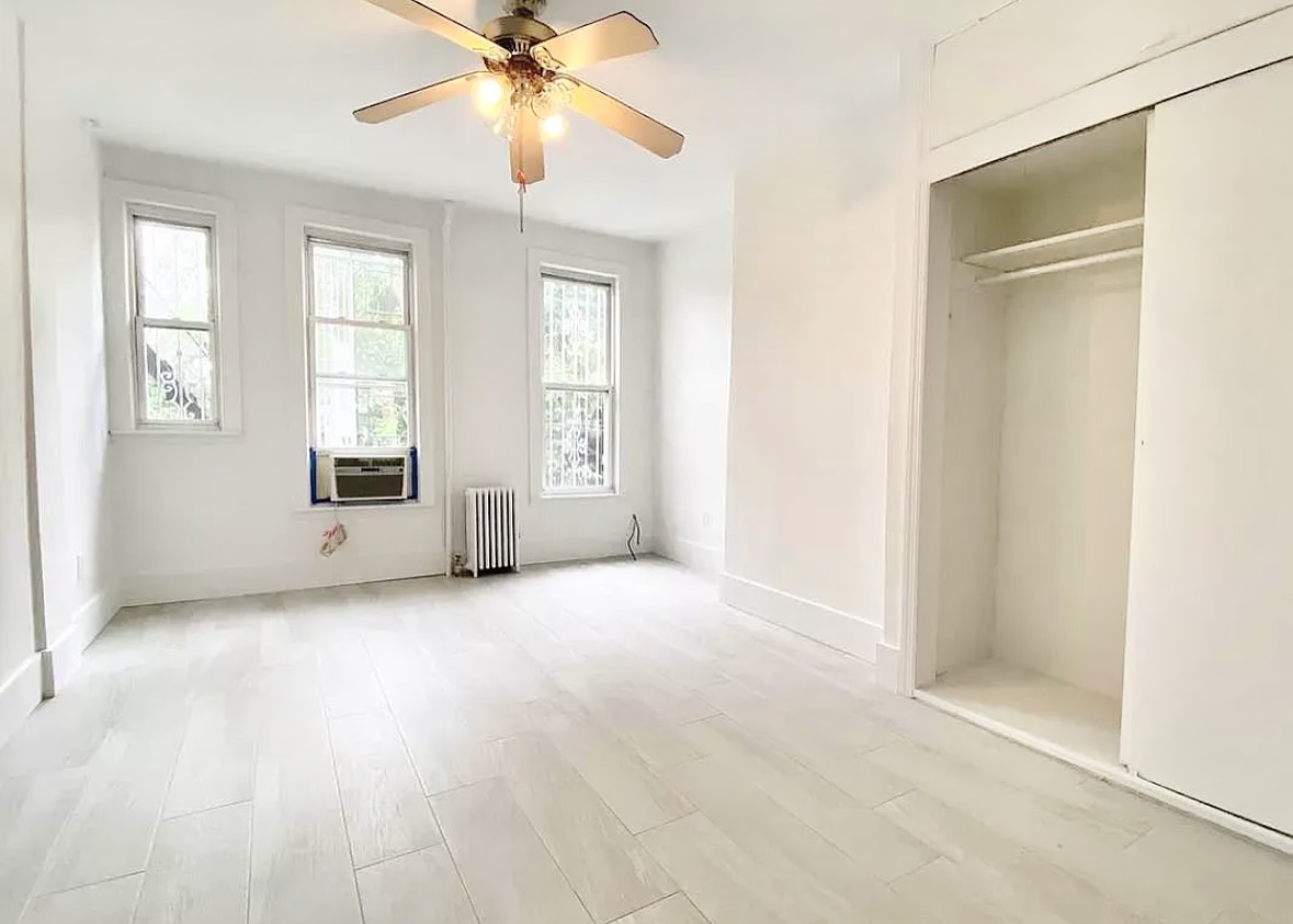 414 Prospect Avenue, Unit 2R Brooklyn, NY 11215 - Photo 2 of 5 an empty room with windows and fan